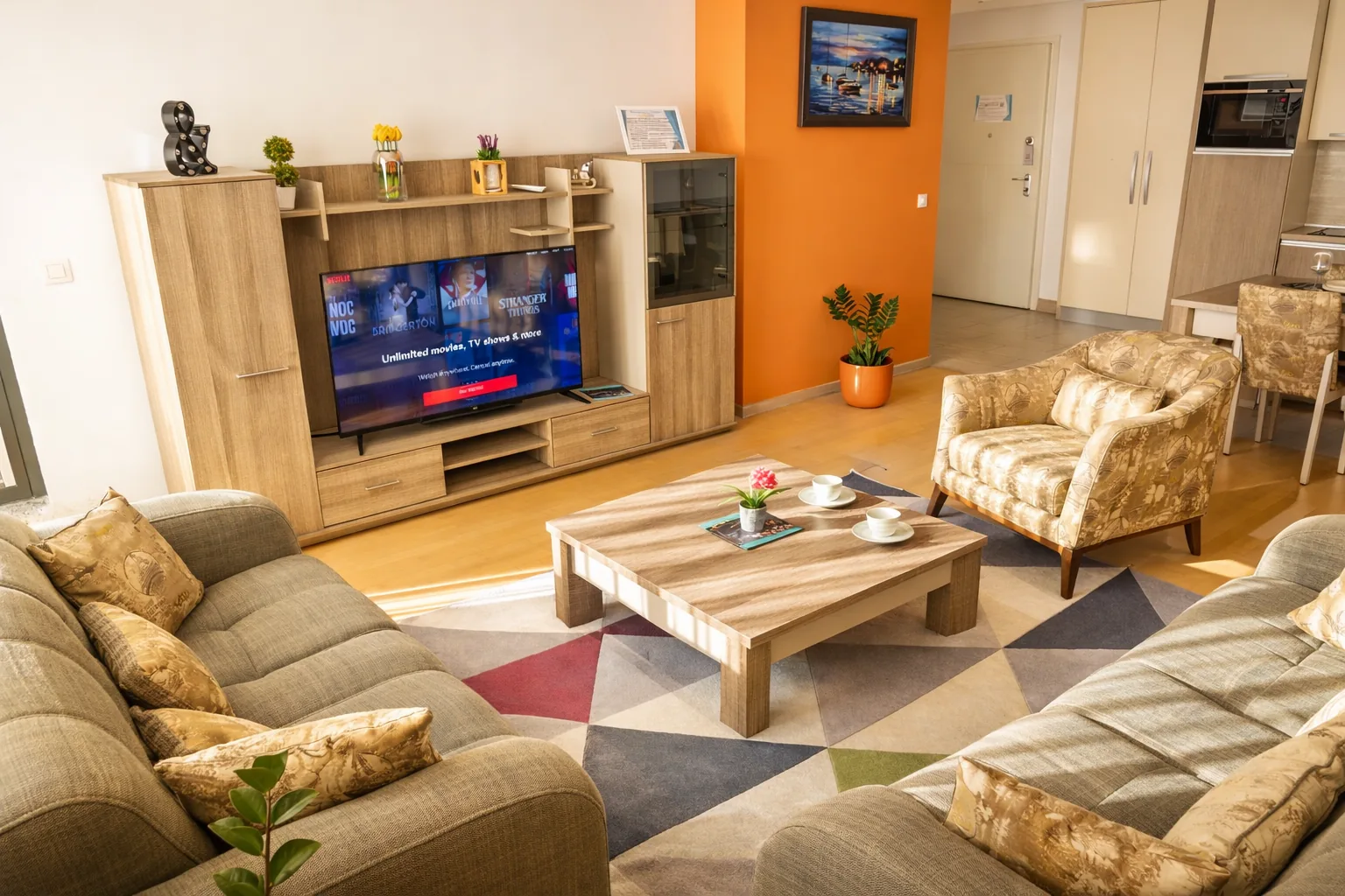 Living room with flat-screen TV, one-bedroom suite at Capitol Suites, Skopje