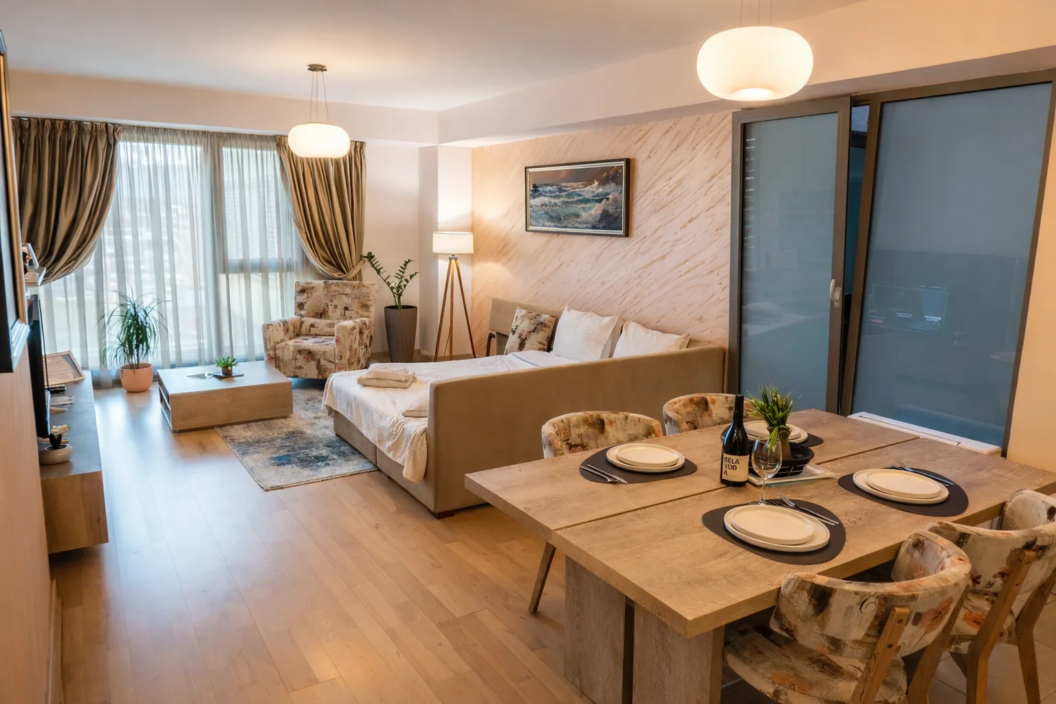 Living room with sofa bed, armchair and dining table, one-bedroom suite at Capitol Suites, Skopje