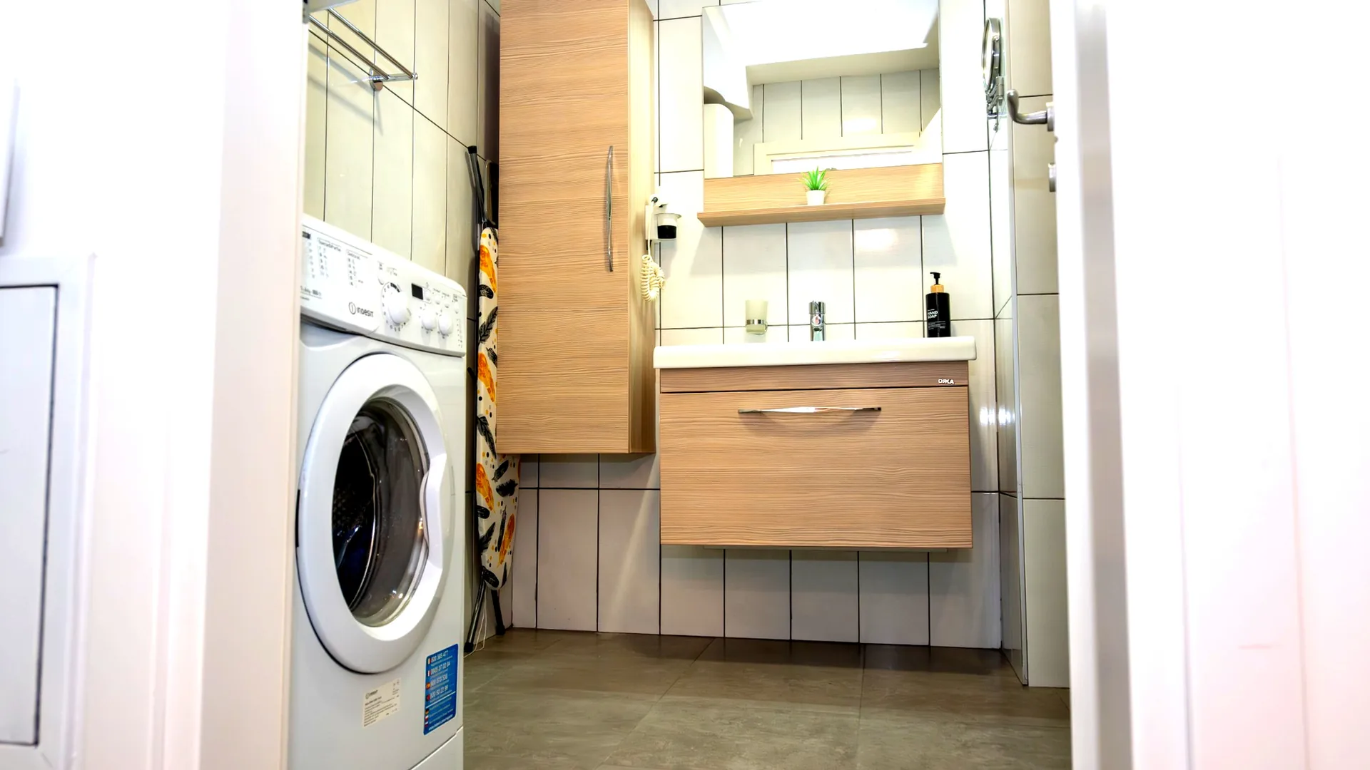 Bathroom with washing machine, vanity and mirror, one-bedroom suite at Capitol Suites, Skopje